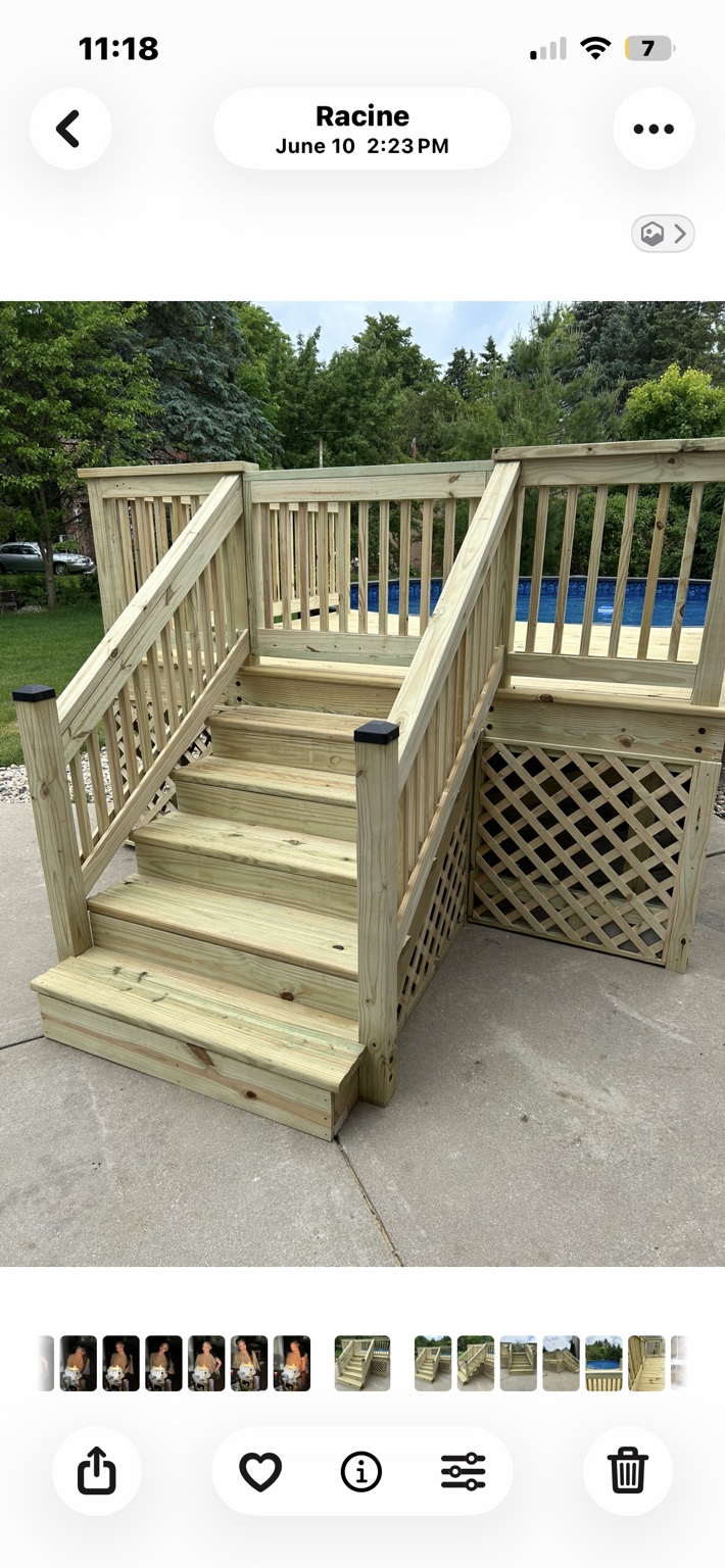 Wood pool deck with wide stairs, a gate, and lattice skirting.